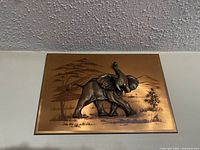 Front view showing entire copper plaque with elephant relief