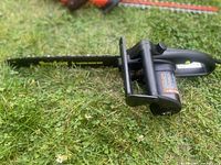 Left side view showing entire chainsaw and bar