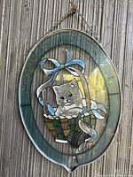 Front view of oval kitten stained glass wall hanging
