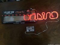 Illuminated LED sign spelling casino with battery pack and original box