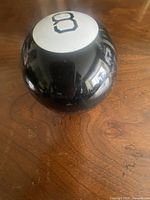 Top view showing white circle with number 8 on black sphere