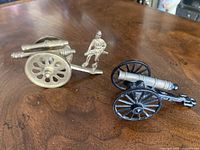 Both cannons side by side on wooden surface