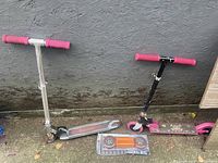 Two scooters side by side, Razor on left, Barbie on right