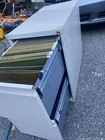 Cabinet with top drawer open showing hanging file rails