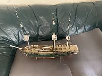 Starboard view of full ship on sofa showing hull color, masts, rigging and stand