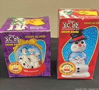 Front view of both boxed snow domes