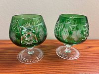 Both Ajka Marsala emerald brandy snifters front view