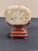 Front view of jade medallion on stand