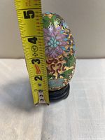 Side view of cloisonné egg on stand with tape showing height ~3.5 in