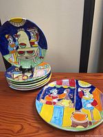 Stack of plates showing multicolour hand-painted designs