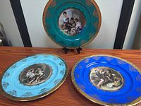 All three Kuba Porzellan plates displaying colors and scenes