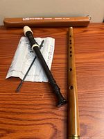 Overall view of recorder, wooden flute, instruction sheet, cleaning rod, case