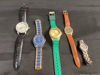 Group shot of five wristwatches showing overall variety
