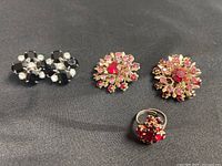 Full group view: black/clear earrings, red/pink earrings, red ring