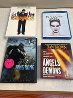 Group shot of four media cases: Arrested Development Season Two (photo shows but not in seller list), Black Swan Blu-ray, King Kong DVD, Angels & Demons audiobook