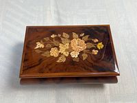 Top view showing floral marquetry and wood finish