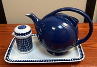 Teapot, lidded jar and tray grouped together