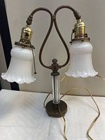 Full view of lamp showing both milk glass shades, double arm, base, and cord