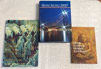 Front covers of all three books laid flat