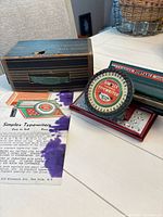 Typewriter with box and instruction sheet displayed on table