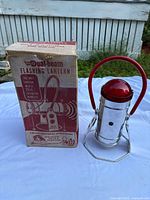 Lantern beside original box showing product name