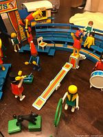 Wide view of circus ring, grandstand, figures, accessories