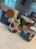 All four matching geometric cotton rope baskets displayed together