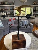 Full view of weathervane showing eagle, arrow, directionals and wood base