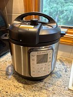 Full view of Instant Pot Duo Plus showing stainless steel body and lid