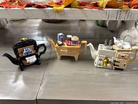 Three Paul Cardew miniature teapots: range cooker, kitchen table, farmhouse sink