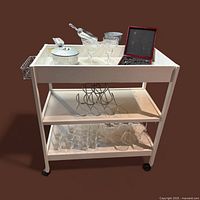 full view of cart with glassware, ice bucket, scoops, bar tool box