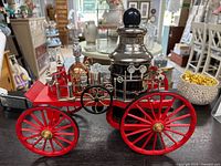 Full side view of red wheeled Jim Beam firetruck decanter