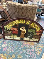 Front view of entire wooden Greene Stead & Sons grocer sign