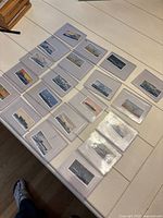 Tabletop view of all cigarette cards laid out in sleeves