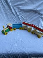 Full view of four-piece wooden toy train assembled