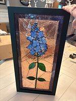 Front view of entire stained glass panel in wood frame