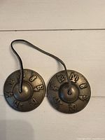 Top view of both cymbals showing embossed symbols and connecting strap