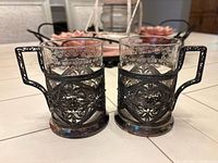 two assembled tea glasses with holders