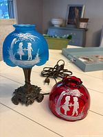 Lamp assembled with blue shade, red shade beside