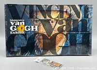 Front view of sealed souvenir book with key chain in packaging