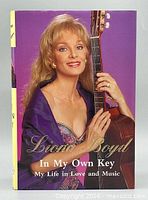Front cover showing title and author holding guitar