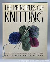 Front cover of hardcover book showing title, author and yarn graphic
