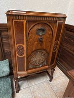 Front view of full radio cabinet showing overall design and dimensions context