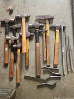 Group view of all hammers, chisels, pry bars on floor