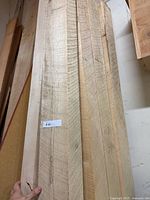 Close view of board faces showing grain and mix of planed and rough surfaces