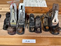 All five hand planes lined up on workbench