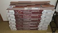 Stack of Pravada Platinum Series Luxury Laminate Flooring cases