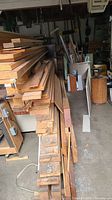 Side view of stacked lumber showing variety of board sizes and colours