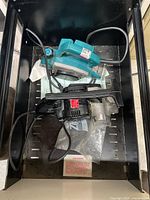 Makita teal planer and black planer in drawer