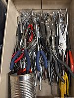 drawer filled with various pliers and locking clamps